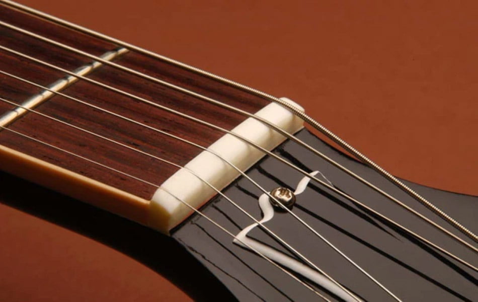 The guitar goes out of tune if the strings aren't in their nut grooves.
